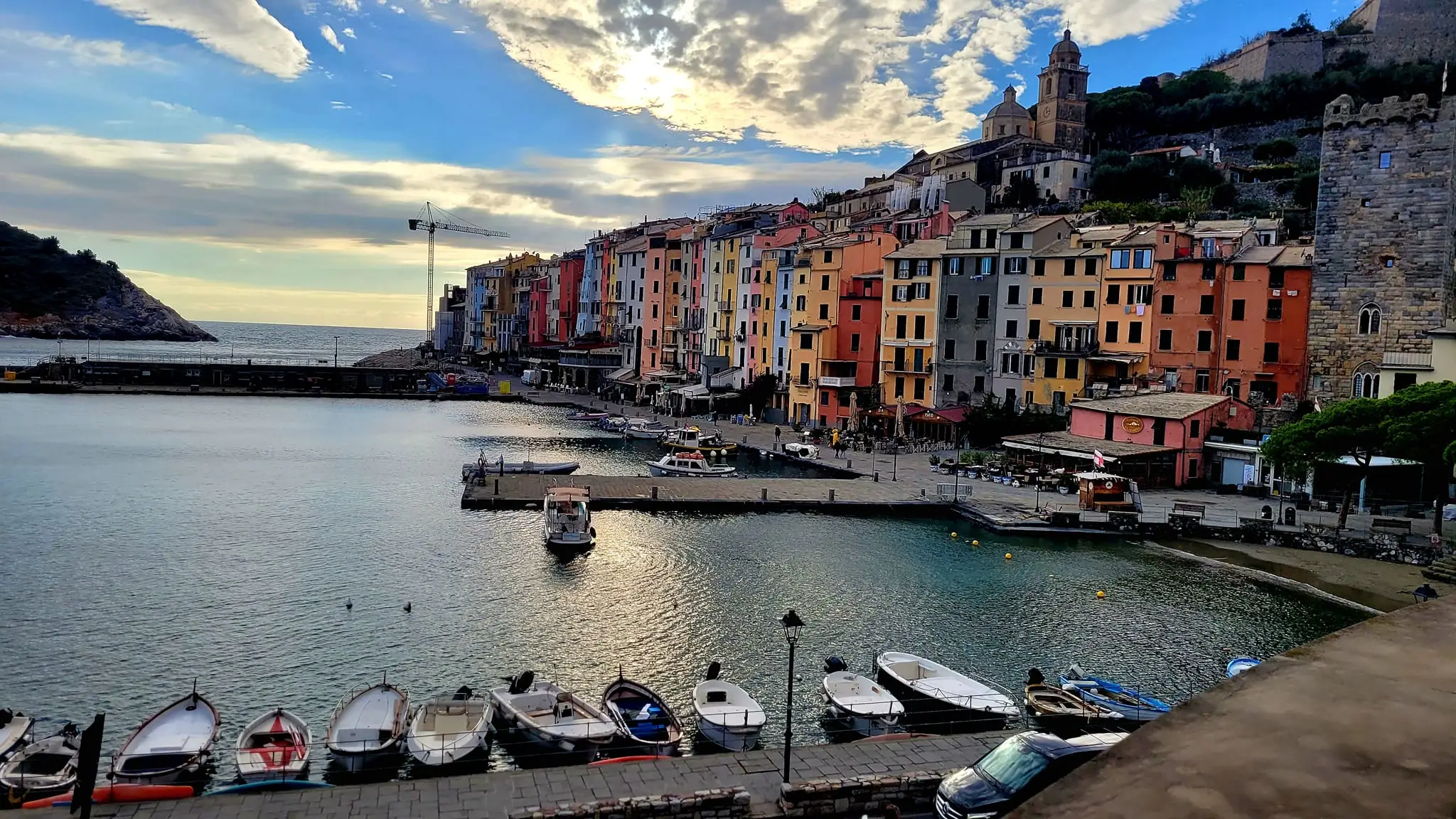 traditional colorful narrow houses od Porto Venere with little port and fishing boats in front