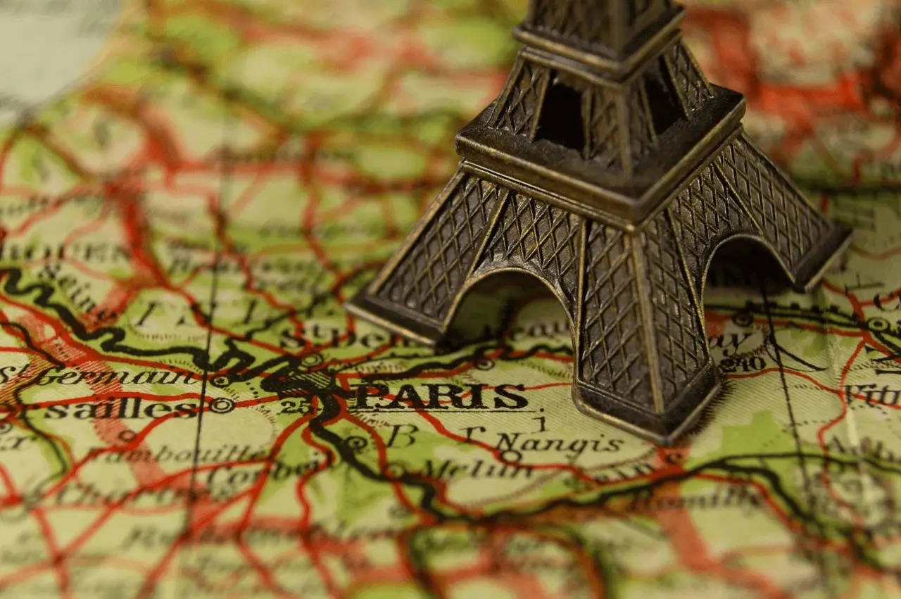picture of map with a small statue of Eiffel tower