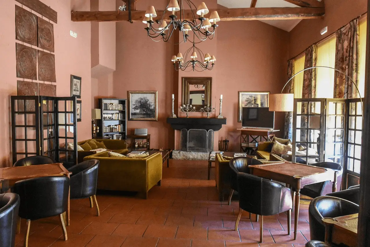 interior of and old cottage with seaties, sofas, ancient fireplace