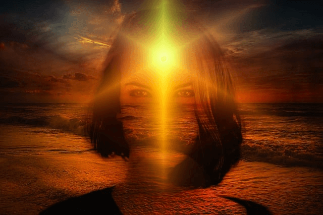 transparent silhouette of woman face with long hair, sun on dark orange sunset background shines through her forhead